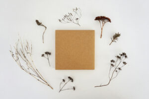 A brown package surrounded by dried flowers