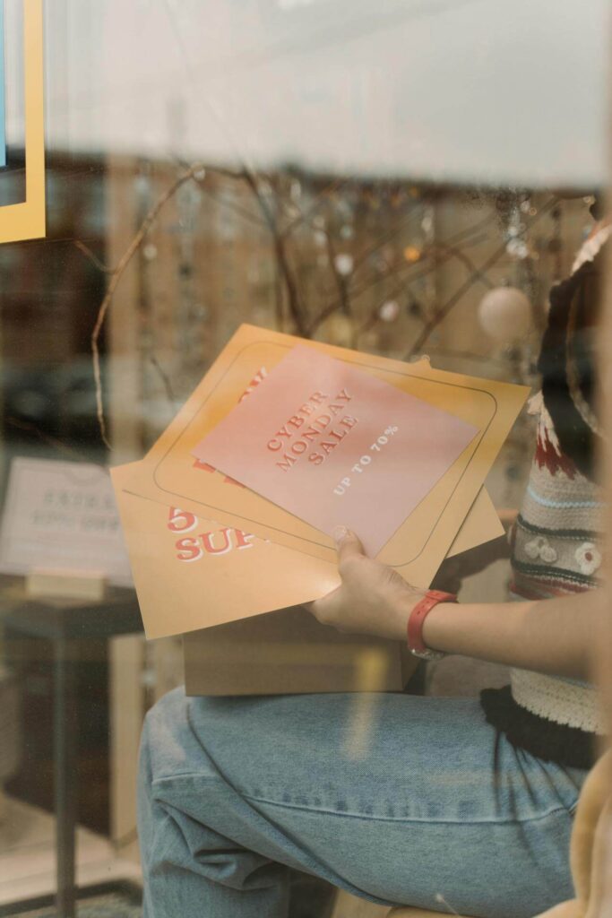 A business owner unboxes various print marketing materials from outsourced comprehensive printing services