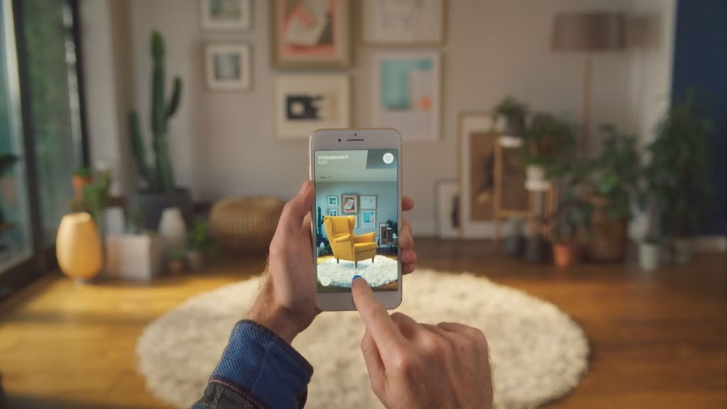 IKEA's augmented reality app in use showing chair being put into in a room. 