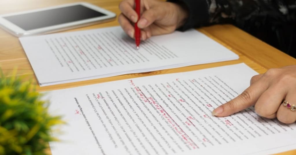 Red marks on paper showing proofreading. 