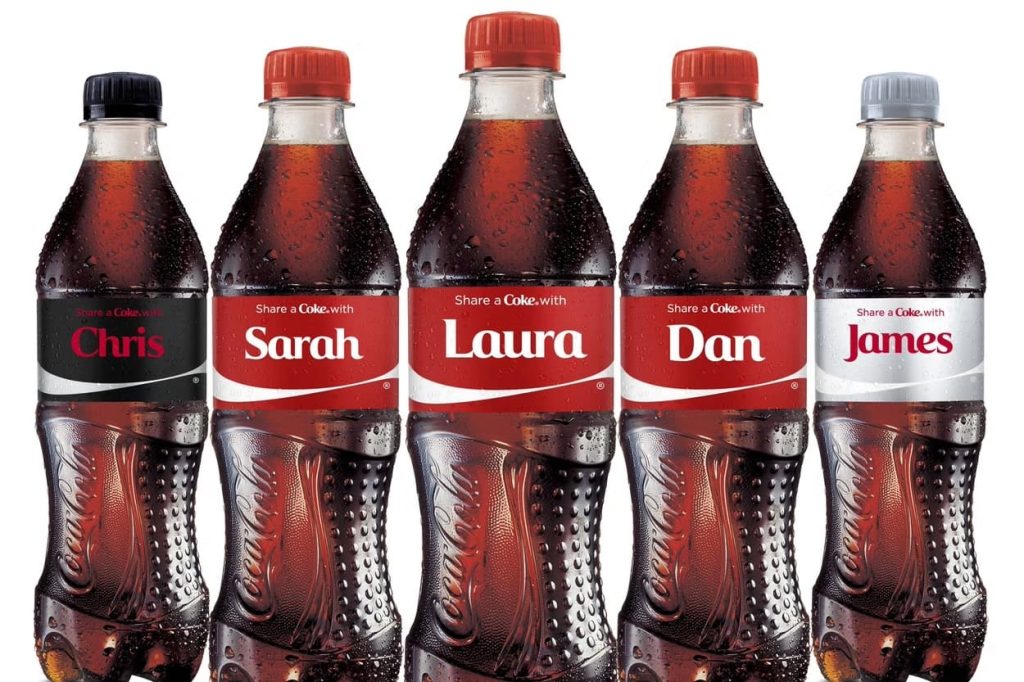 Share a Coke bottles showing variable data printing on labels with custom names.