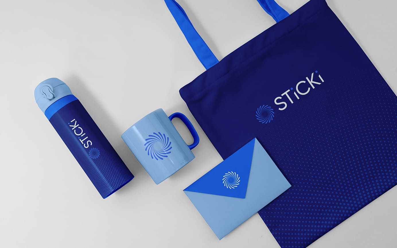 Sticki branded promo including a waterbottle, tote bag, and mug laying flat.